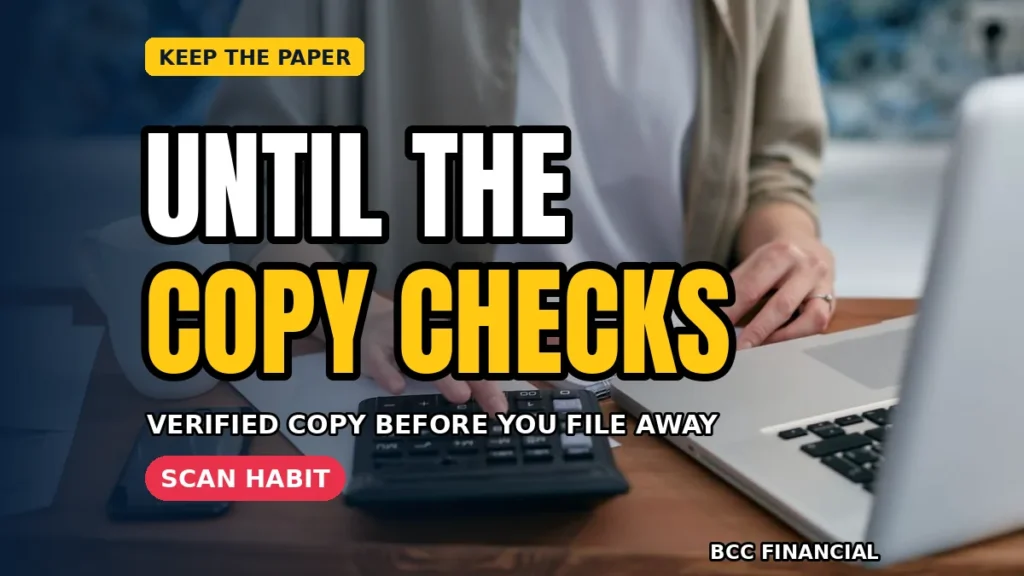 A scanner, a small stack of receipts and a laptop showing tidy year folders on a clean office desk