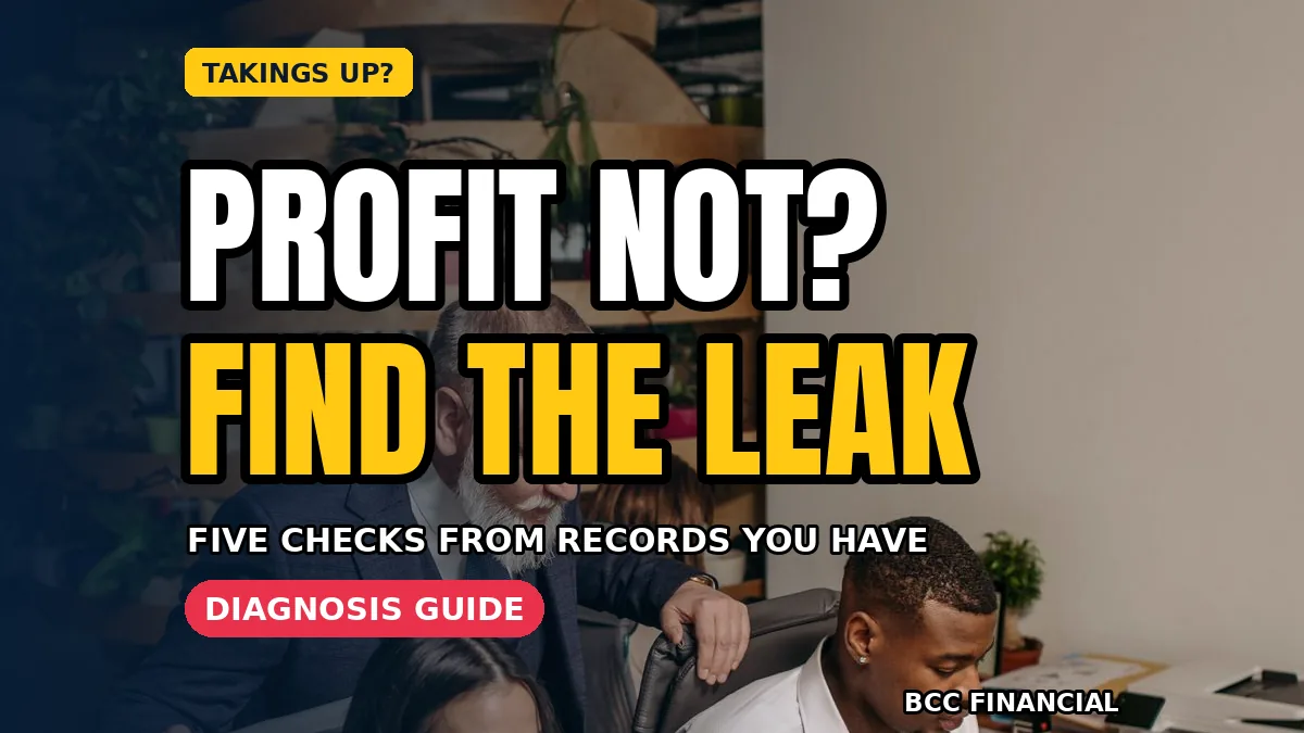 Owner working through sales up profit down small business checks with invoices and a calculator at a shop desk