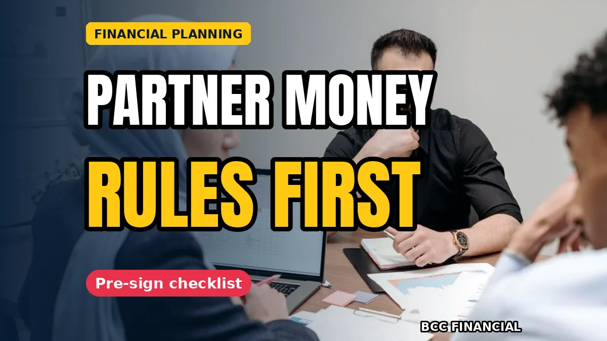 Two business partners shaking hands over signed agreement papers on a desk