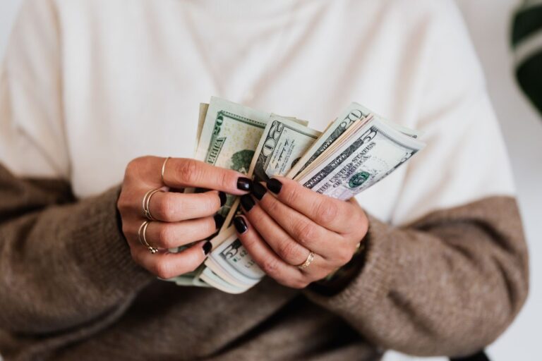 Hands counting cash carefully as part of a daily cash handling routine