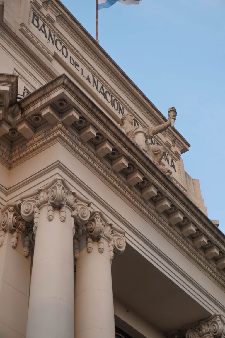 The columned exterior of a bank building where business cash is deposited