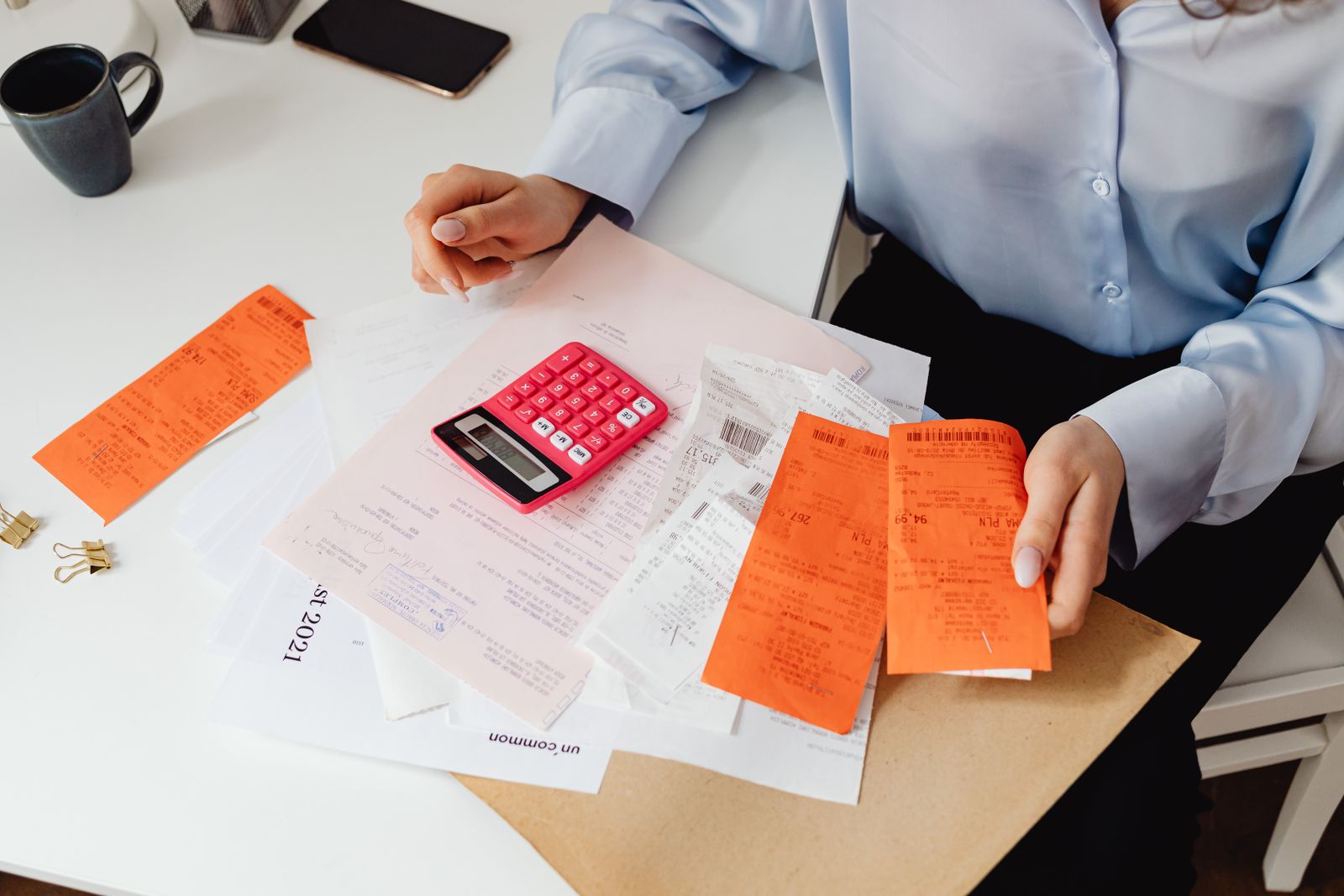 A calculator, receipts and a worksheet used to set an annual business budget