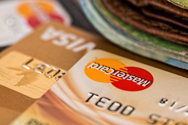 Two bank cards beside a wallet, kept separate from everyday personal spending